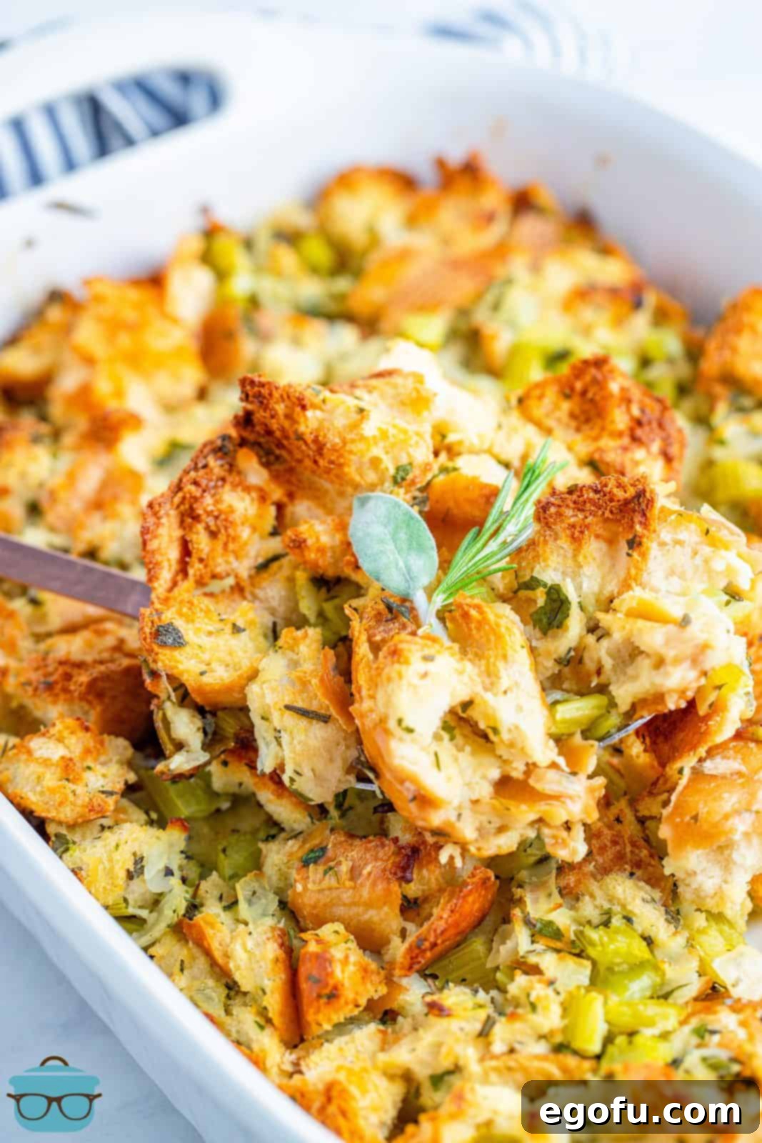 The stuffing mixture poured into a baking dish, topped with butter slices, and ready for the oven.