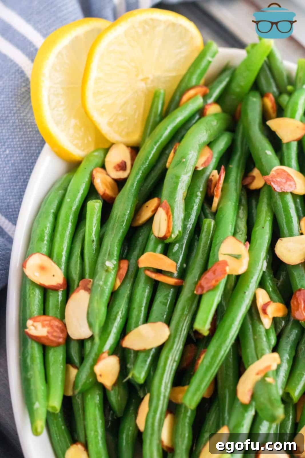 Close up over head of Almond Green Beans with lemon slices.