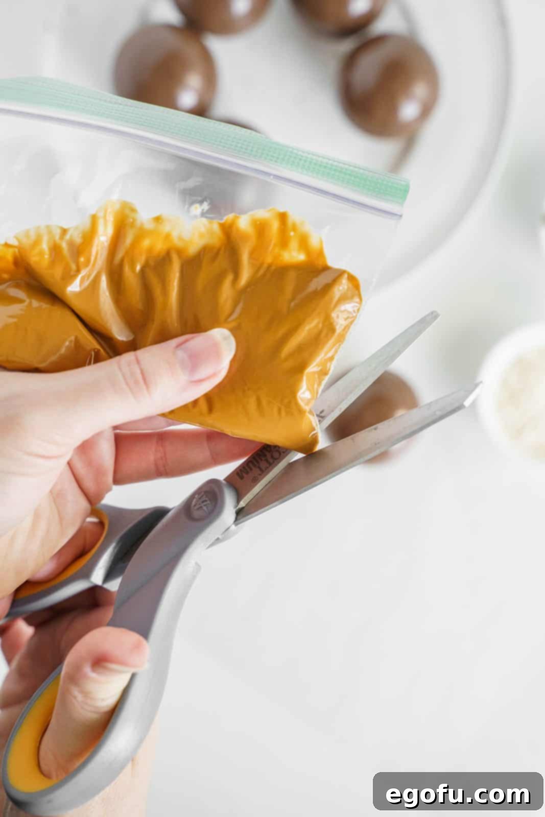 Melted peanut butter candy melts added to bag with tip being cut off.