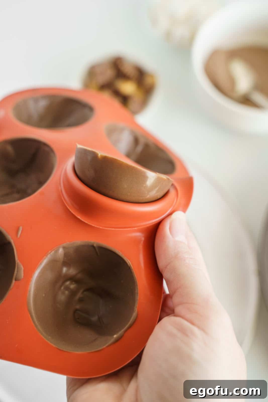Chocolate being gently removed from mold.