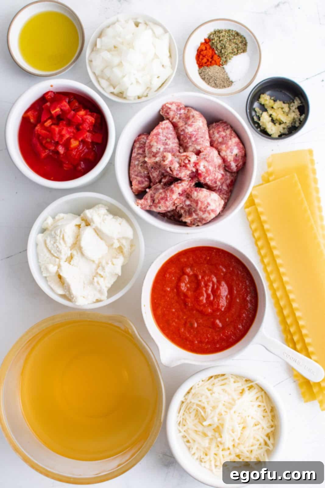 Ingredients needed: olive oil, onion, garlic, Italian seasoning, paprika, salt, pepper, italian ground sausage, chicken broth, petite diced tomatoes, marinara sauce, lasagna noodles, ricotta cheese and mozzarella cheese.