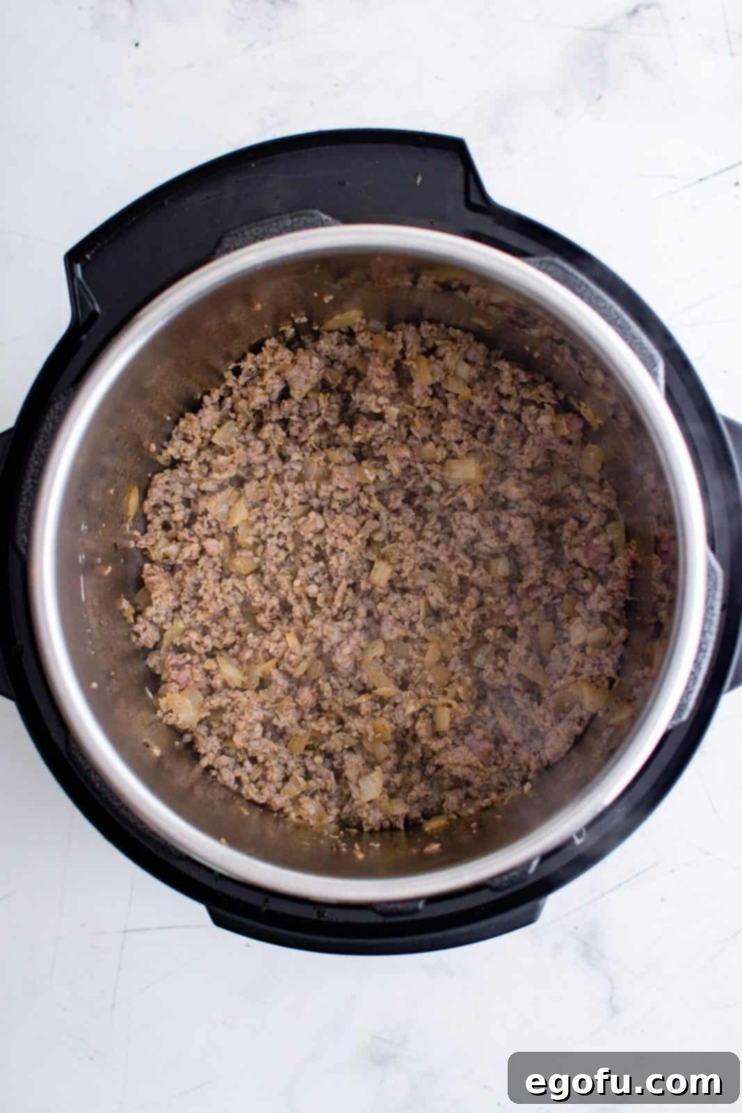 Ground italian sausage added to instant pot and cooked.