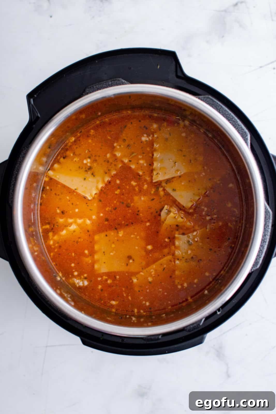 Broken lasagna noodles and remaining broth added to instant pot.