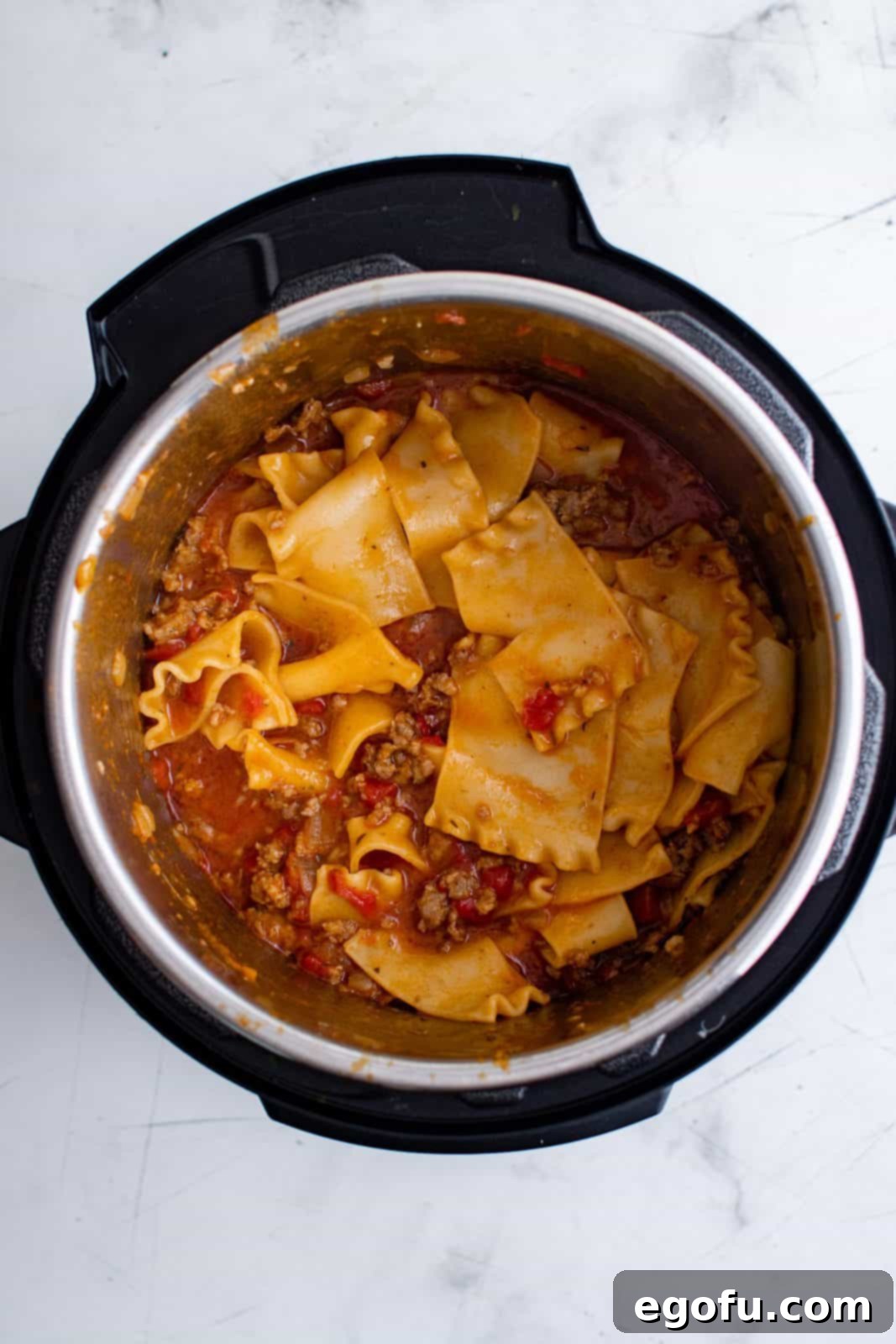 Cooked and stirred noodle mixture in instant pot.