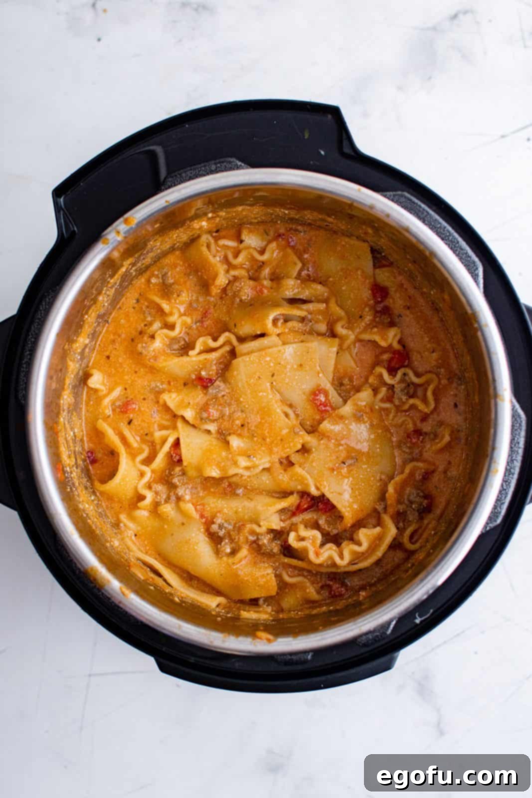 Ricotta and mozzarella cheese stirred into instant pot mixture.