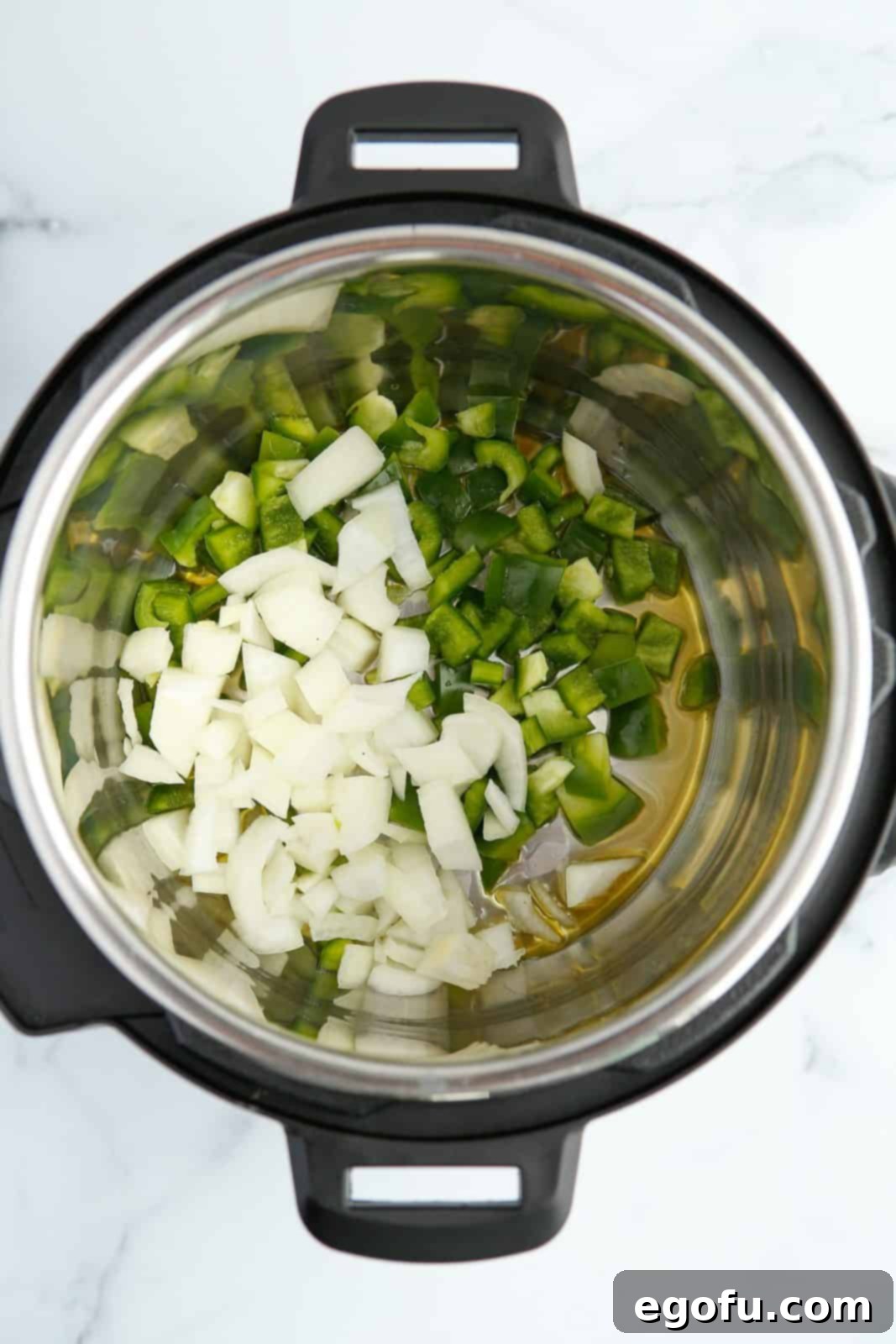 Oil, onions and green pepper in instant pot.