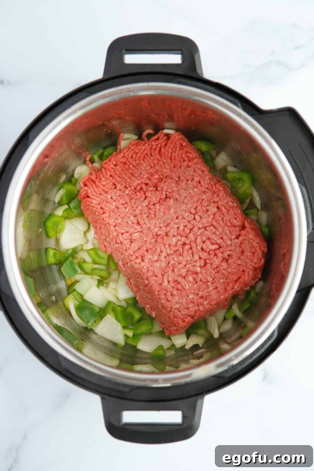 Onions, pepper and ground beef in instant pot.