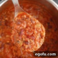 Square image of spoon holding Instant Pot Chili.