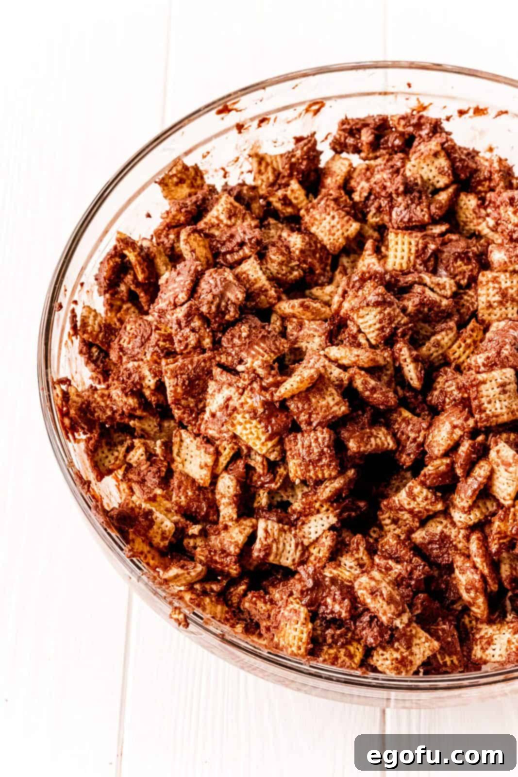Chex cereal in bowl covered in nutella and chocolate mixture.