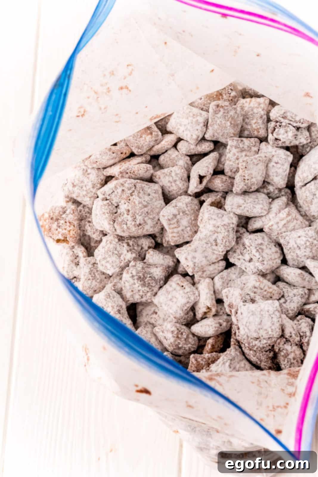 Chex mixture in ziptop bag covered with powdered sugar.