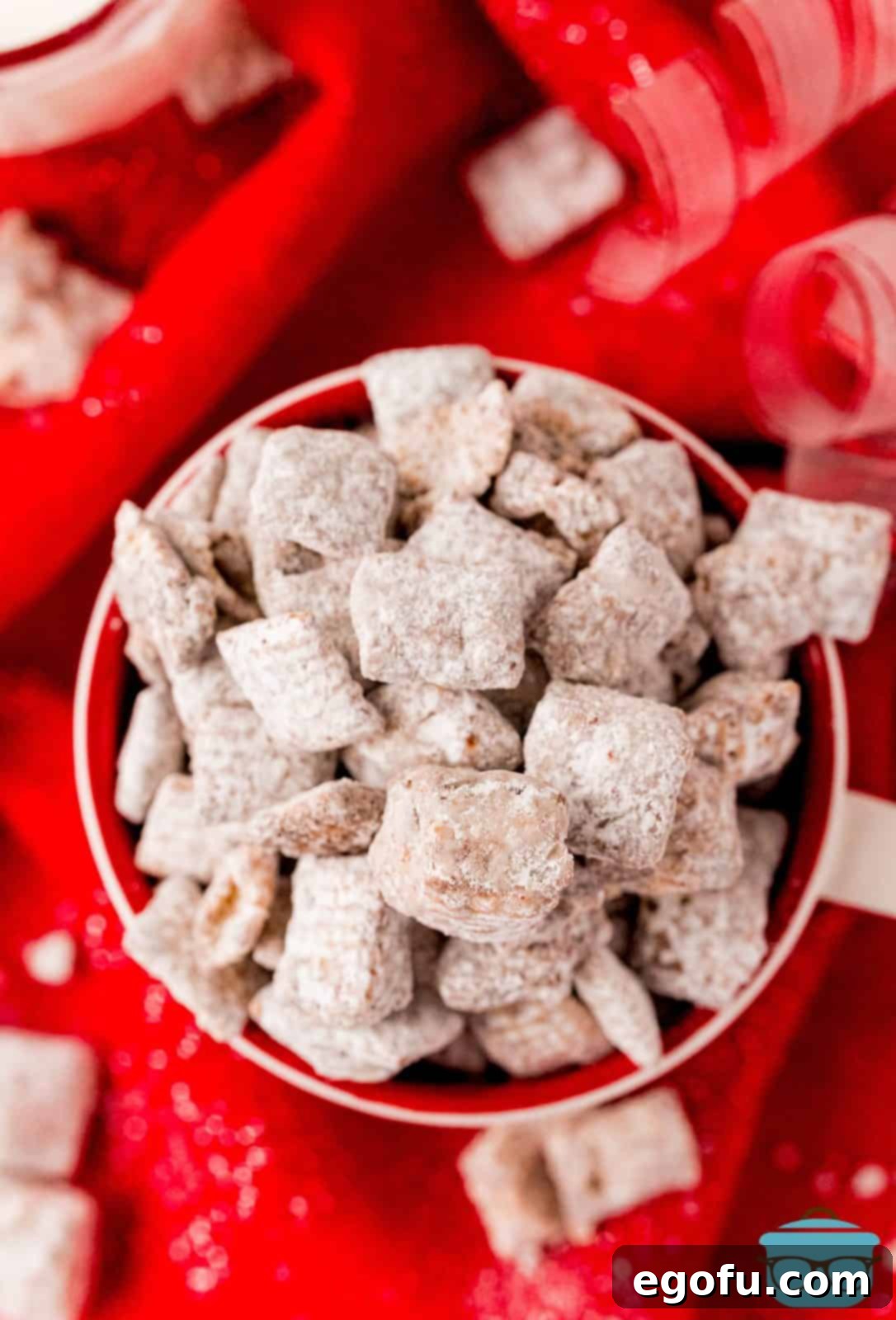 Overhead of Nutella Puppy Chow recipe in bowl on red linen.