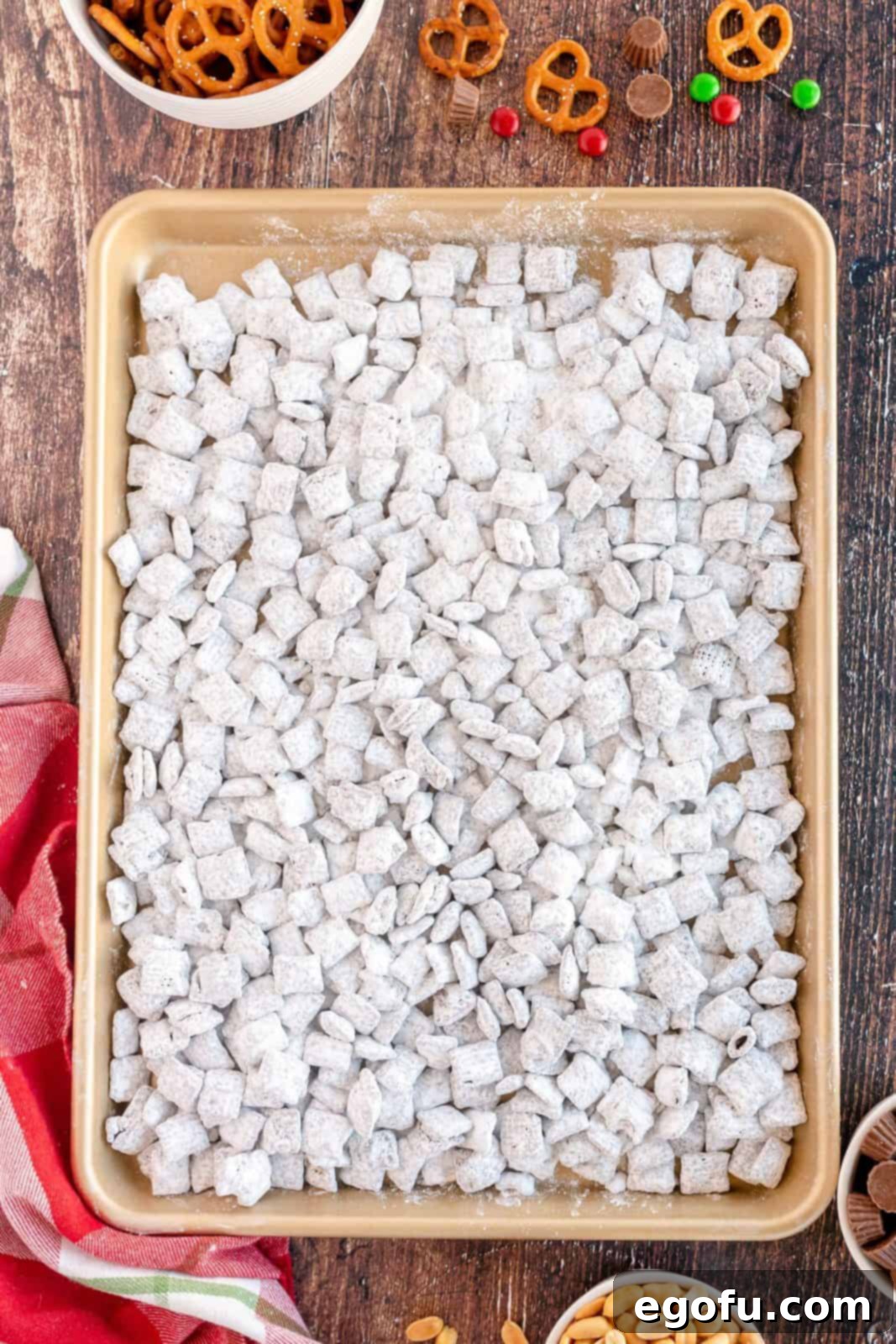 Powdered sugar covered cereal cooling on baking sheet.