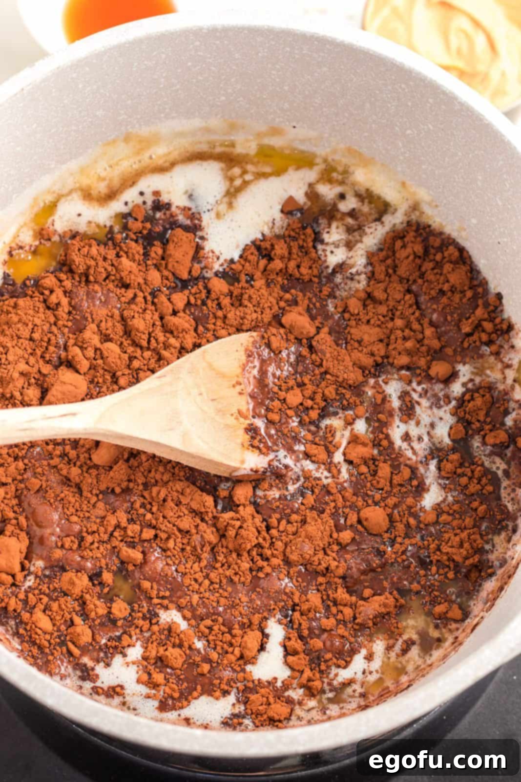 Cocoa, milk, and vanilla extract added to the brown sugar and butter mixture in pan.