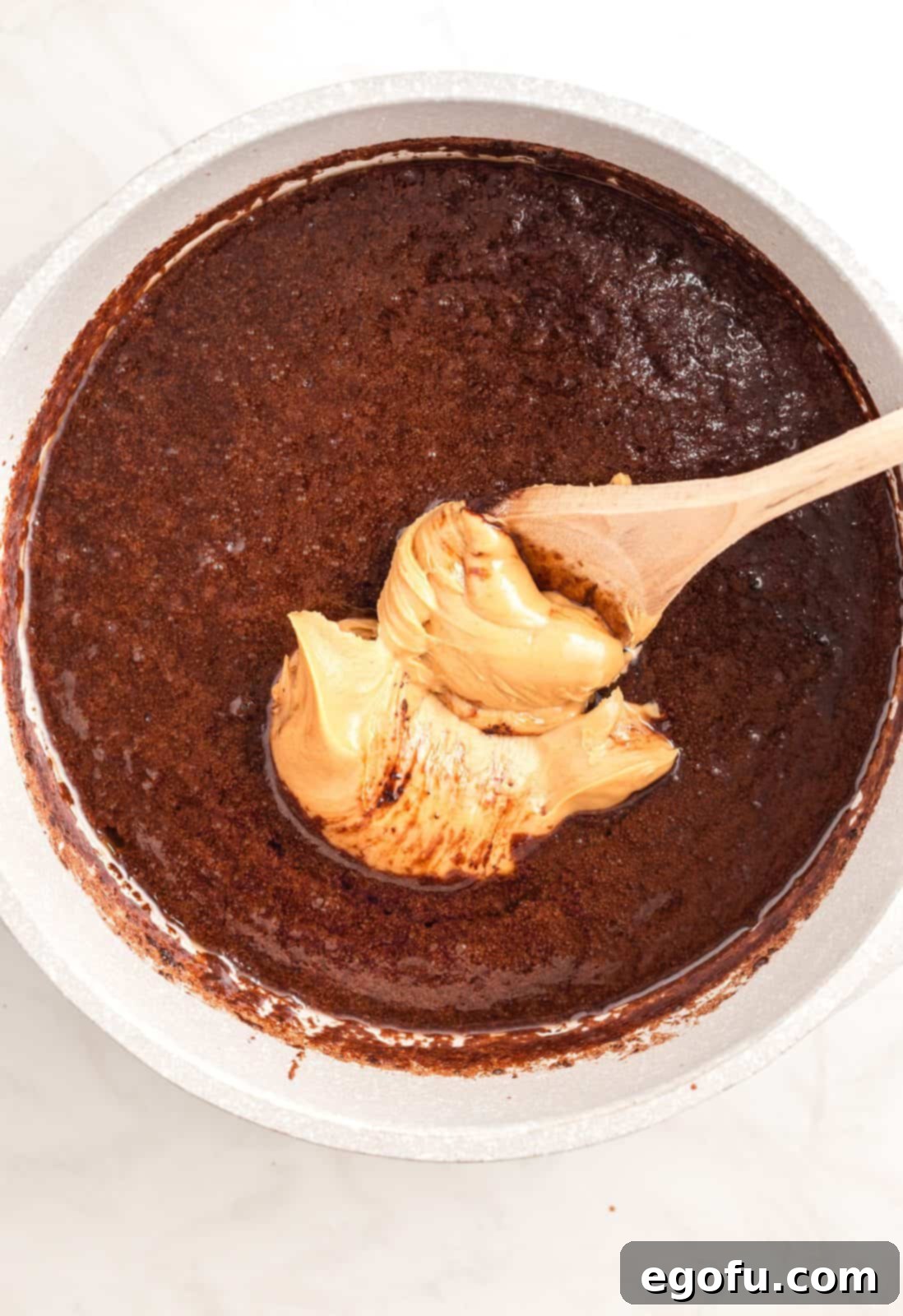 Peanut butter added to cocoa mixture in pan.