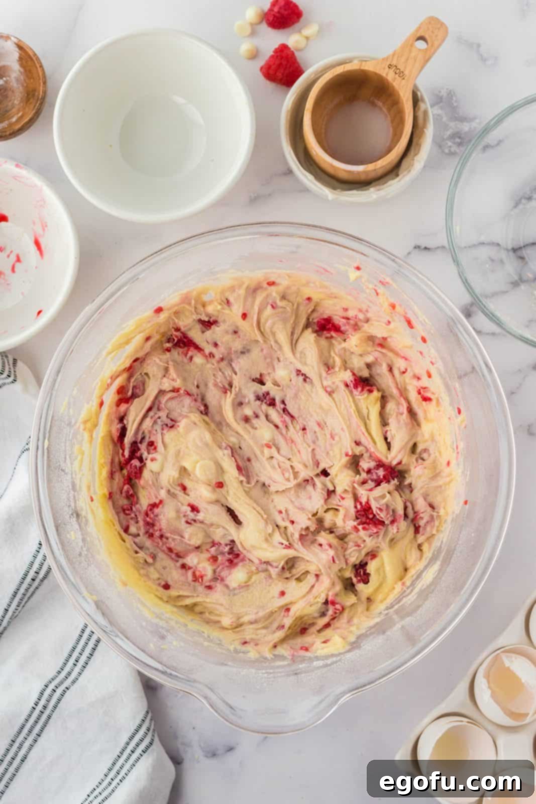 Raspberries and white chocolate chips folded into batter.