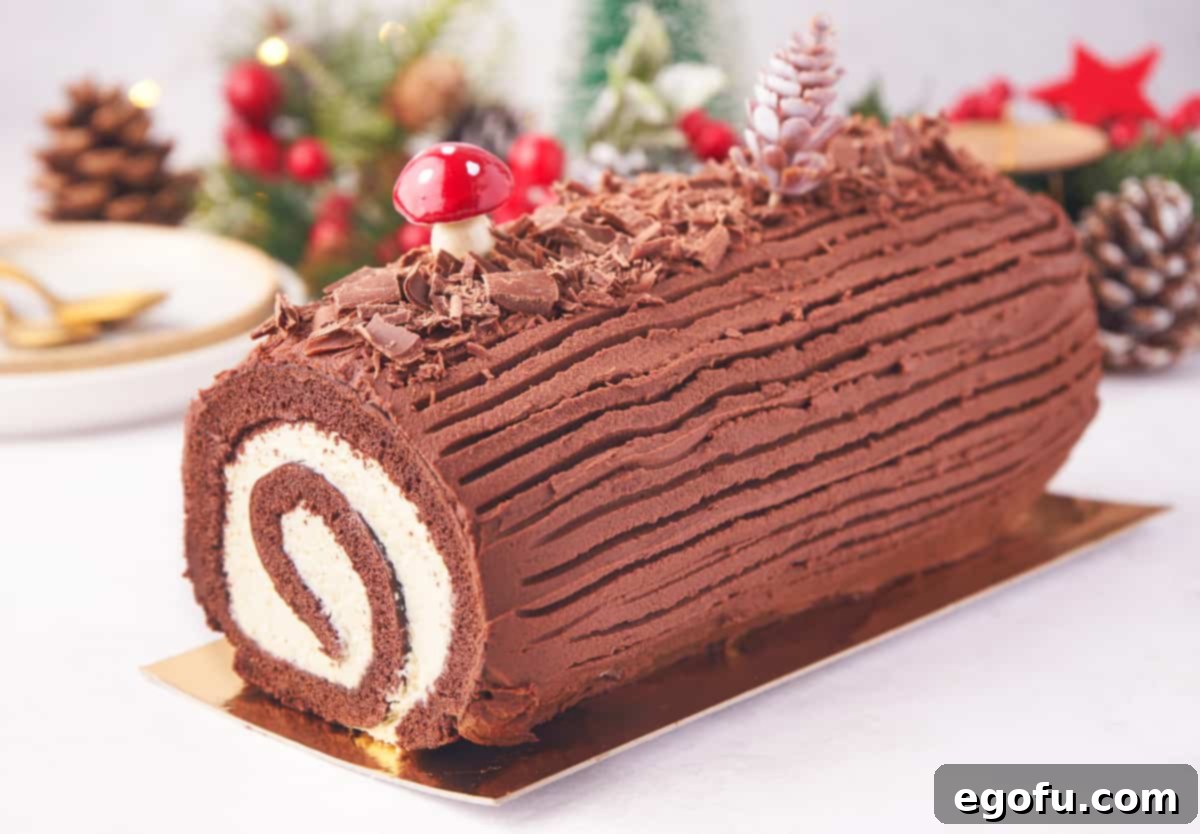 Side view of Christmas Yule Log Cake decorated showing inside swirl.