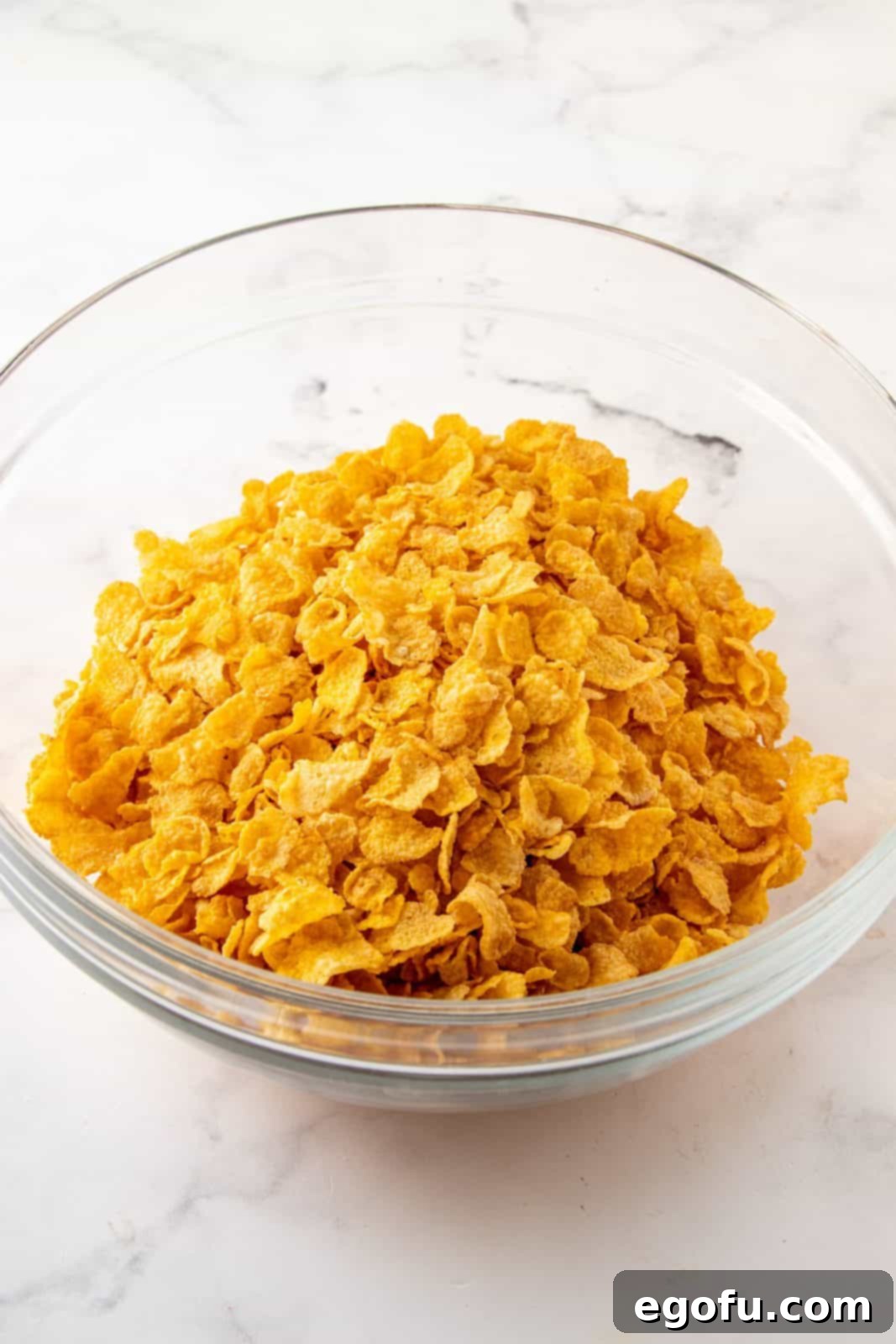 Grandmas Effortless No Bake Cornflake Delights 5 Unsweetened cornflakes perfectly measured and placed in a large mixing bowl, ready for the next step.