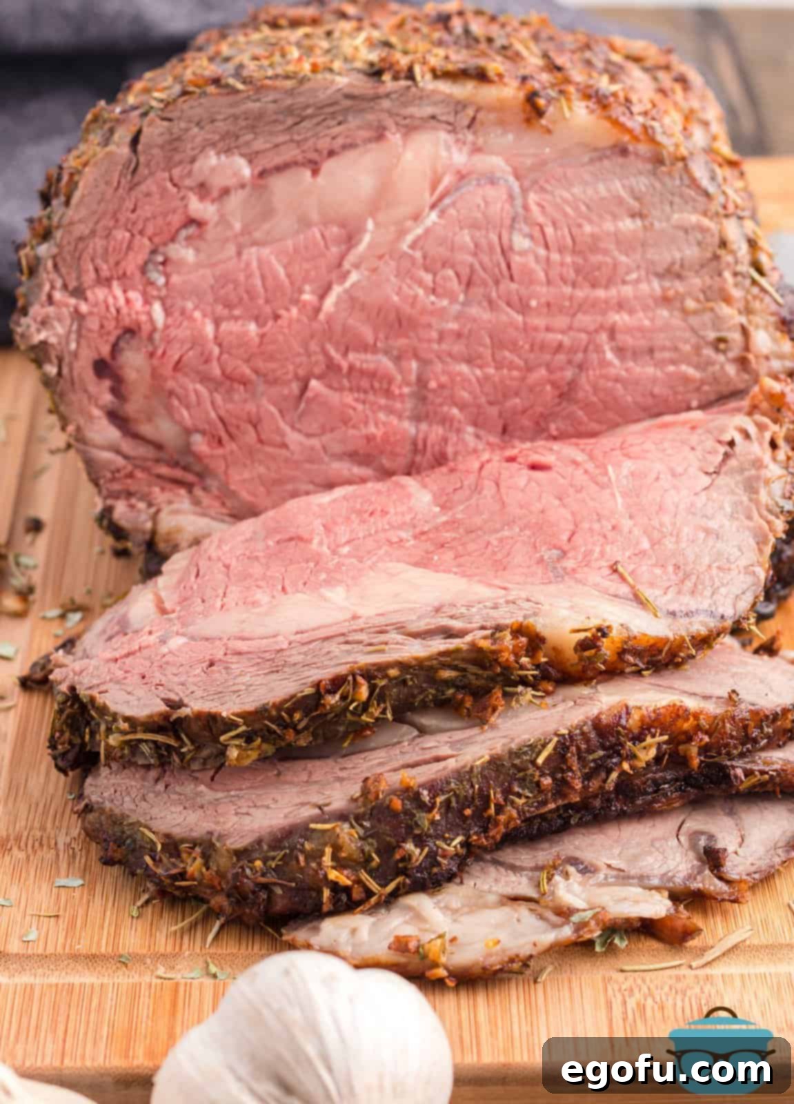 Perfectly sliced Garlic Butter Prime Rib on a cutting board, ready to serve.