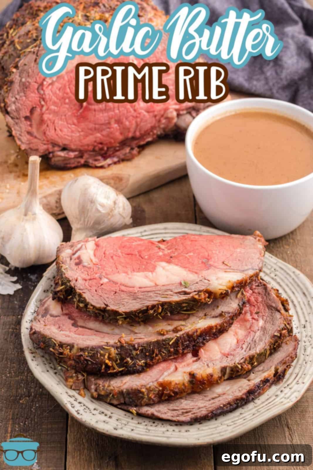 Close-up of perfectly cooked Prime Rib slices with a side of savory au jus, garnished with fresh herbs.