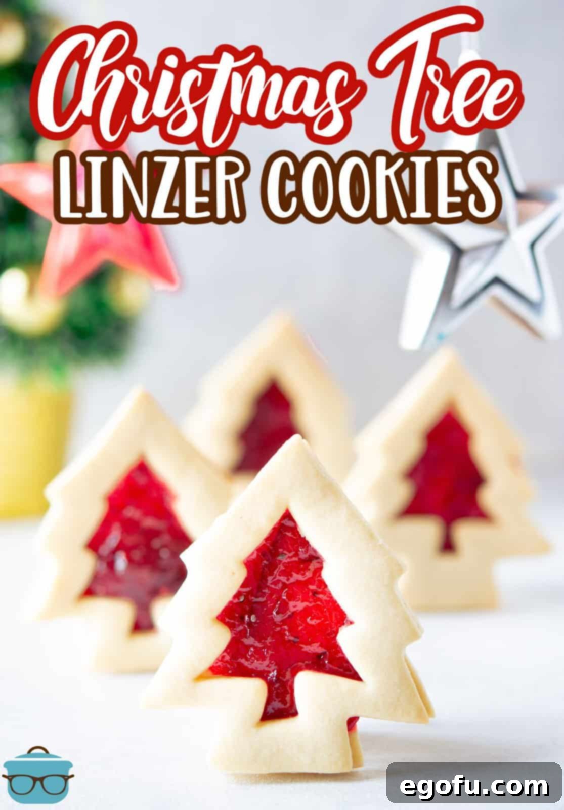 Christmas Tree Linzer Cookies standing up showing jam filling.