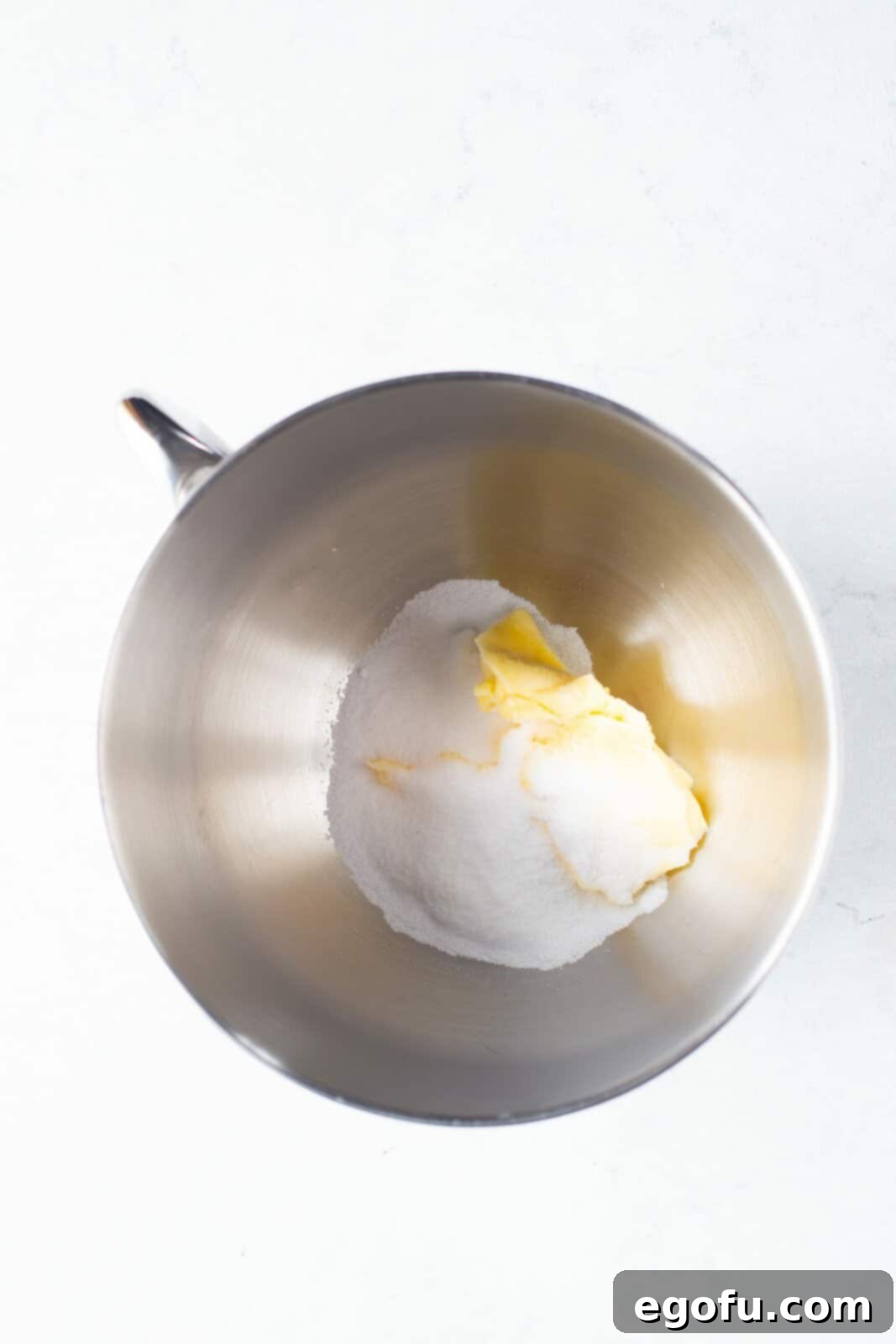 Butter and sugar in bowl of stand mixer.