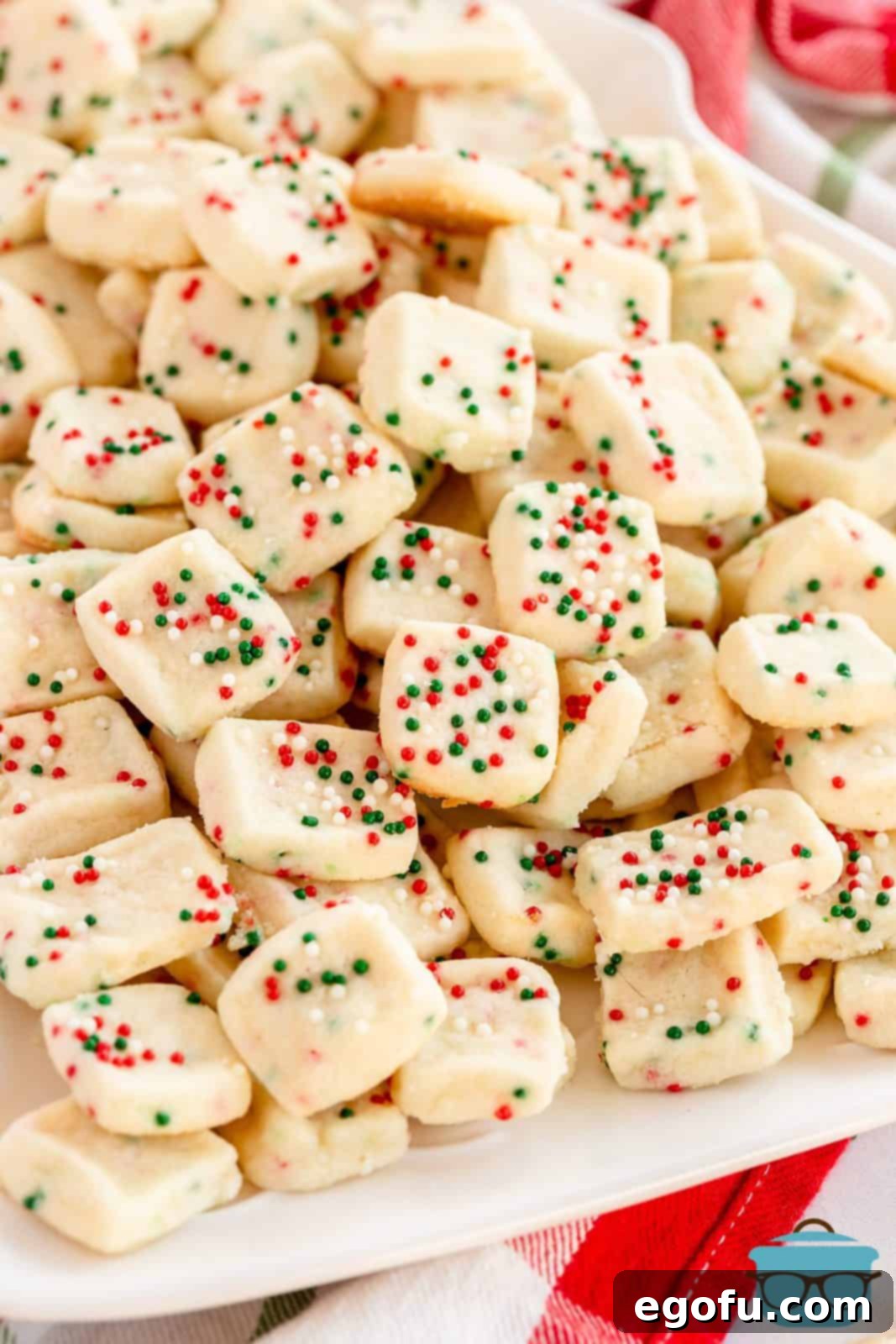 A close-up view of perfectly baked Mini Christmas Shortbread Cookies arranged invitingly on a platter.