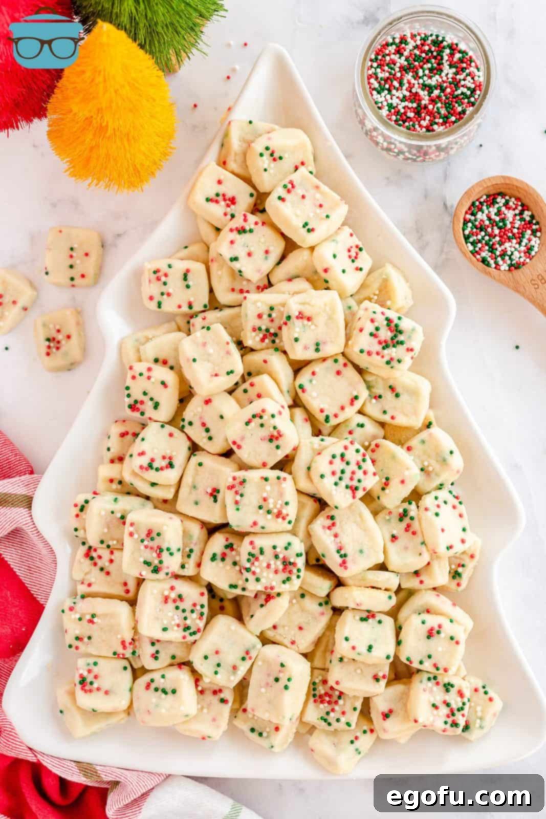 An overhead shot of Mini Christmas Shortbread Cookies arranged beautifully on a Christmas tree-shaped platter.