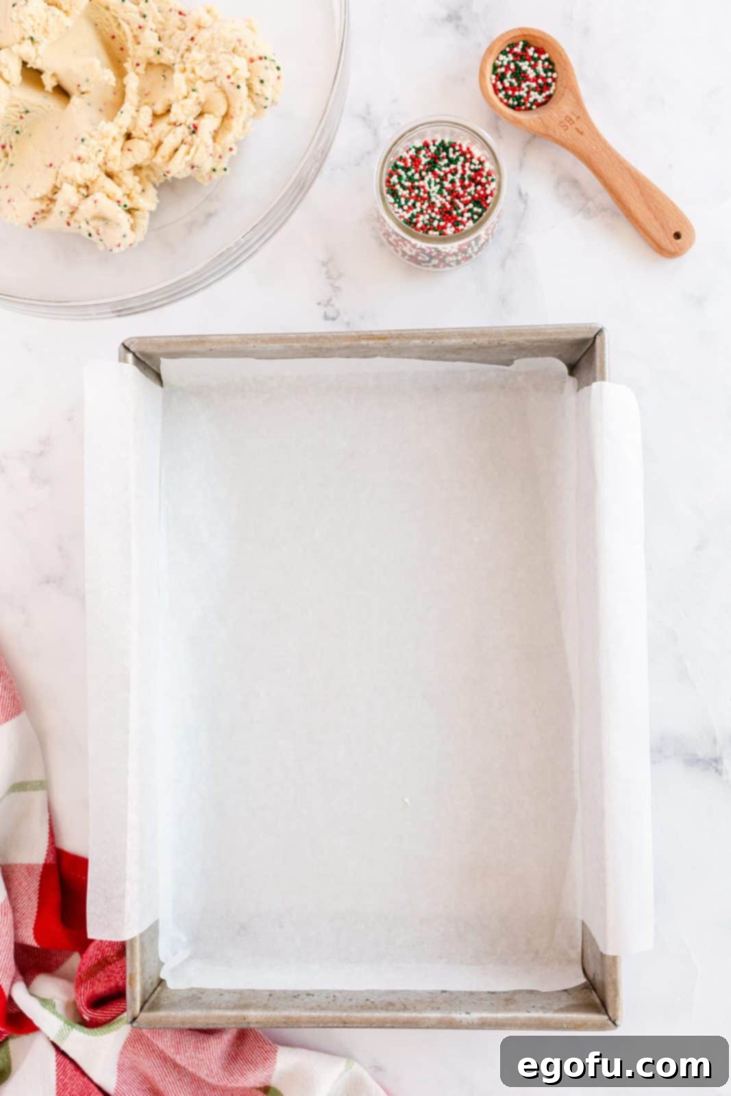 Baking pan lined with parchment paper, ready for the shortbread dough.
