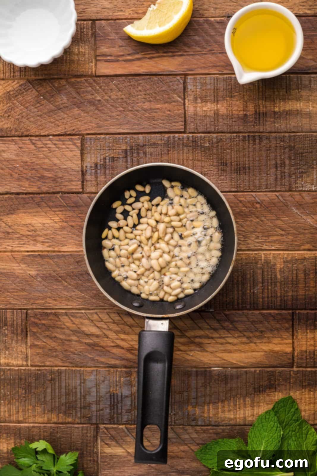 Succulent Lamb Chops 10 Pine nuts gently toasting in a small skillet over high heat, turning golden brown and releasing their nutty aroma.