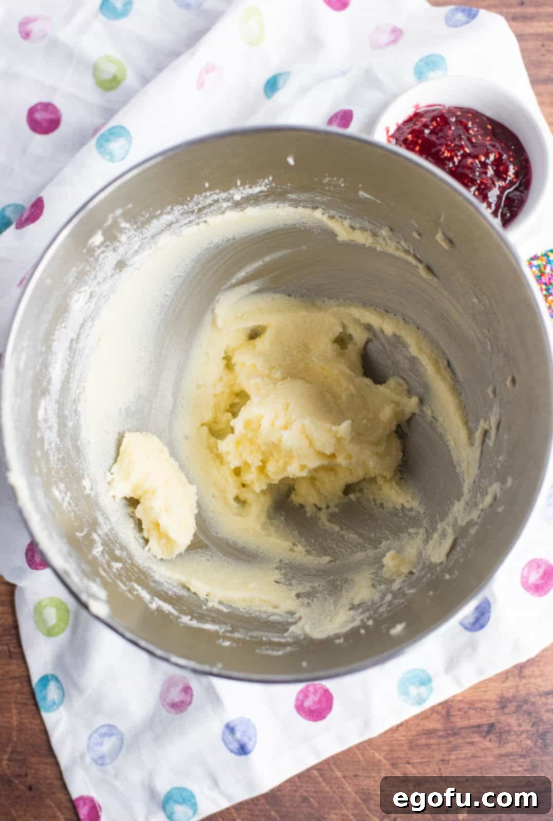 Softened butter and granulated sugar being thoroughly creamed together in the bowl of a stand mixer until light and fluffy.