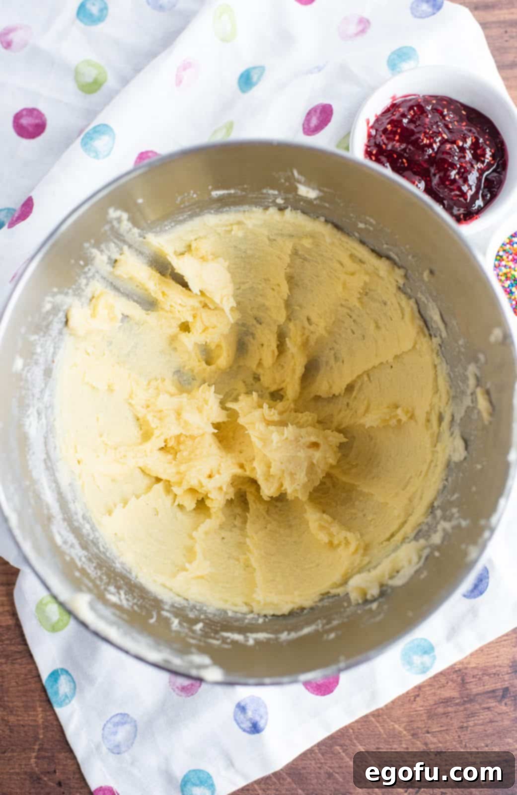 Egg yolks and salt added and beaten into the creamy butter and sugar mixture.