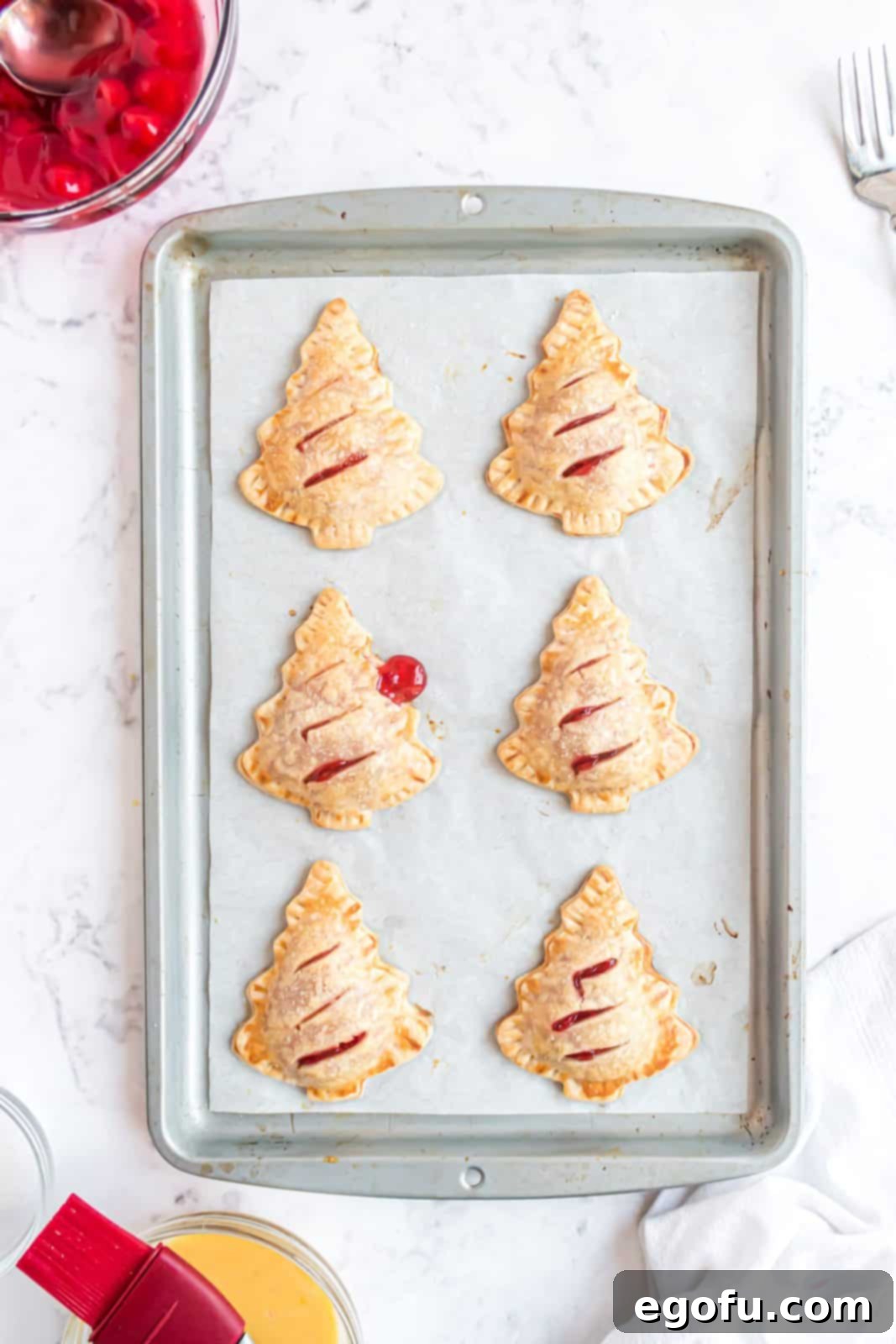 Finished Christmas Tree Hand Pies right out of oven, golden brown and glistening with sanding sugar.