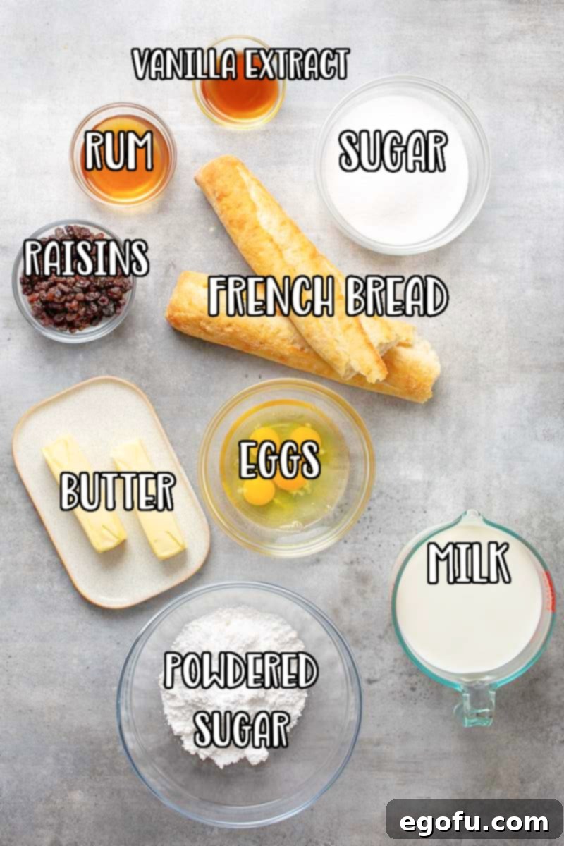 A vibrant flat lay of all the essential ingredients for making the best bread pudding: butter, French bread, plump raisins, fresh milk, eggs, granulated sugar, aromatic vanilla extract, dark rum or whisky, and a pile of powdered sugar for the glaze.