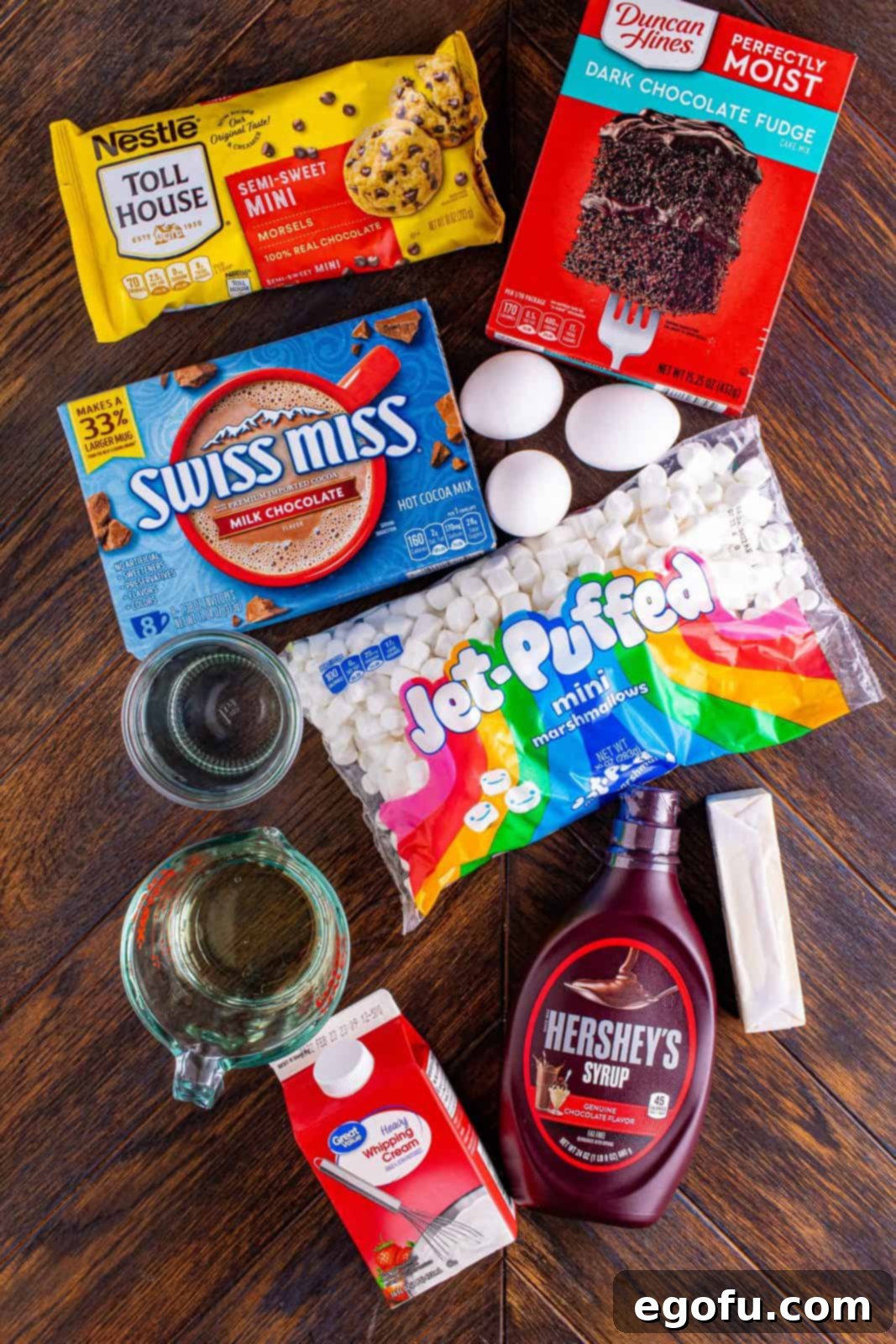 dark chocolate cake mix, hot chocolate mix, eggs, oil, mini marshmallows, butter, chocolate syrup, heavy cream.