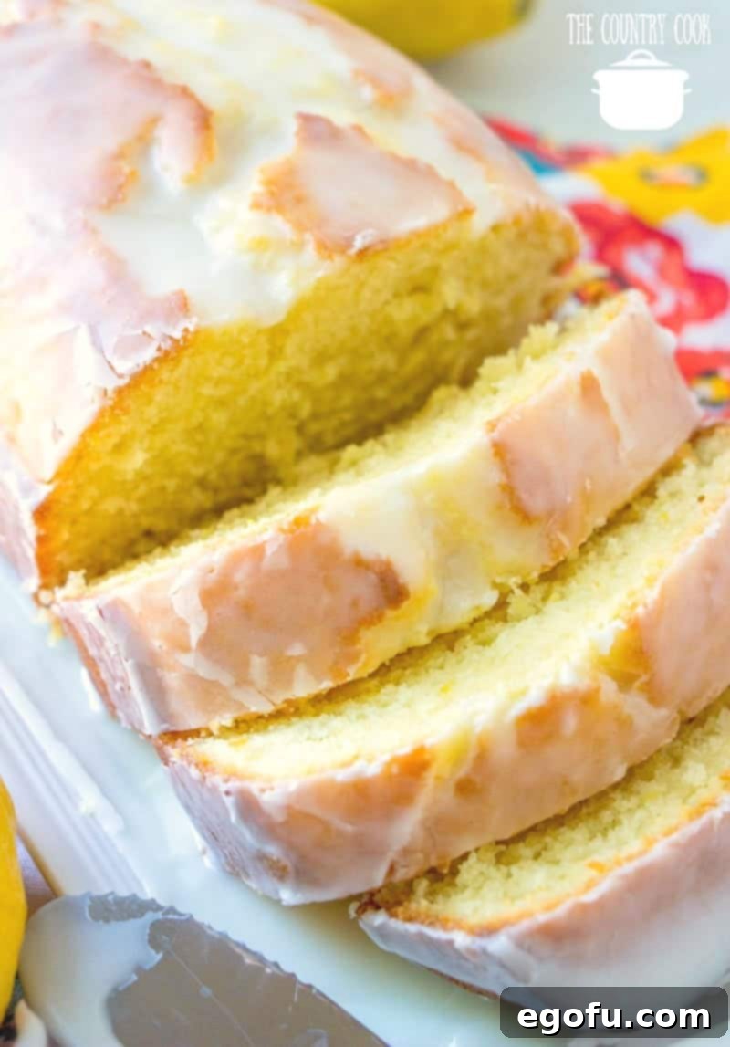 Starbucks Zesty Lemon Loaf 12 Easy Homemade Copycat Starbucks Lemon Loaf recipe, beautifully sliced on a white platter, inviting a taste.