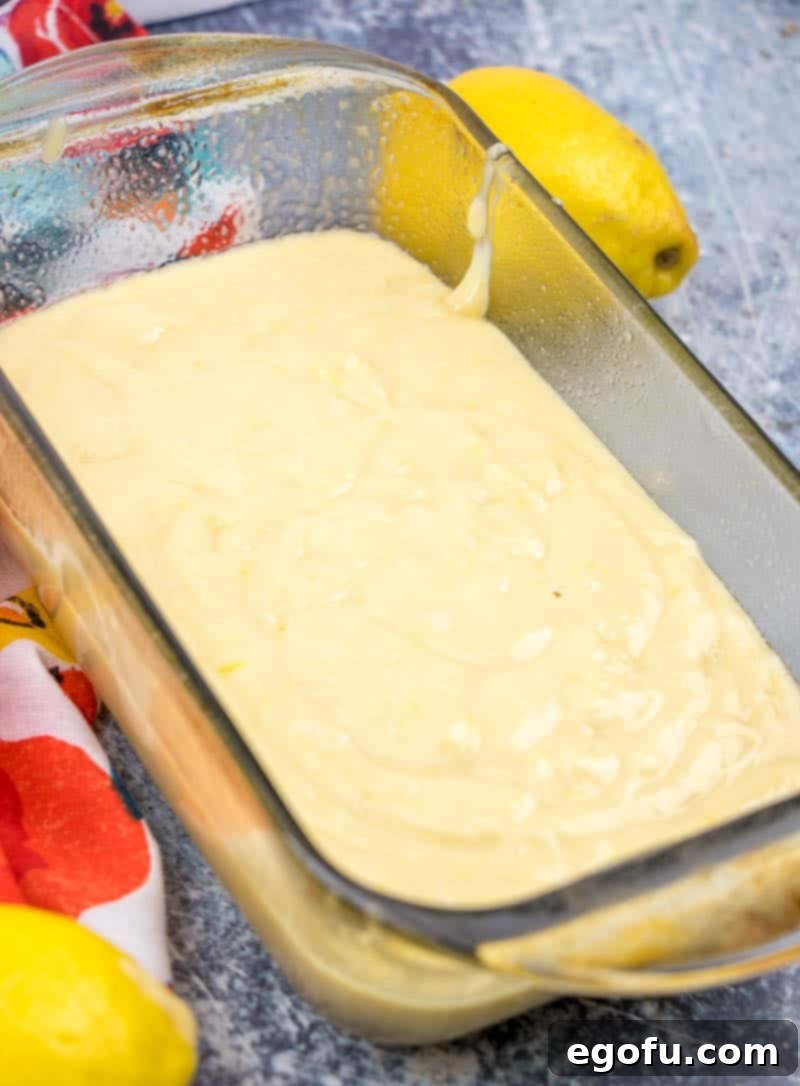 Starbucks Zesty Lemon Loaf 9 Lemon loaf batter is carefully poured into a glass baking dish, ready for the oven.