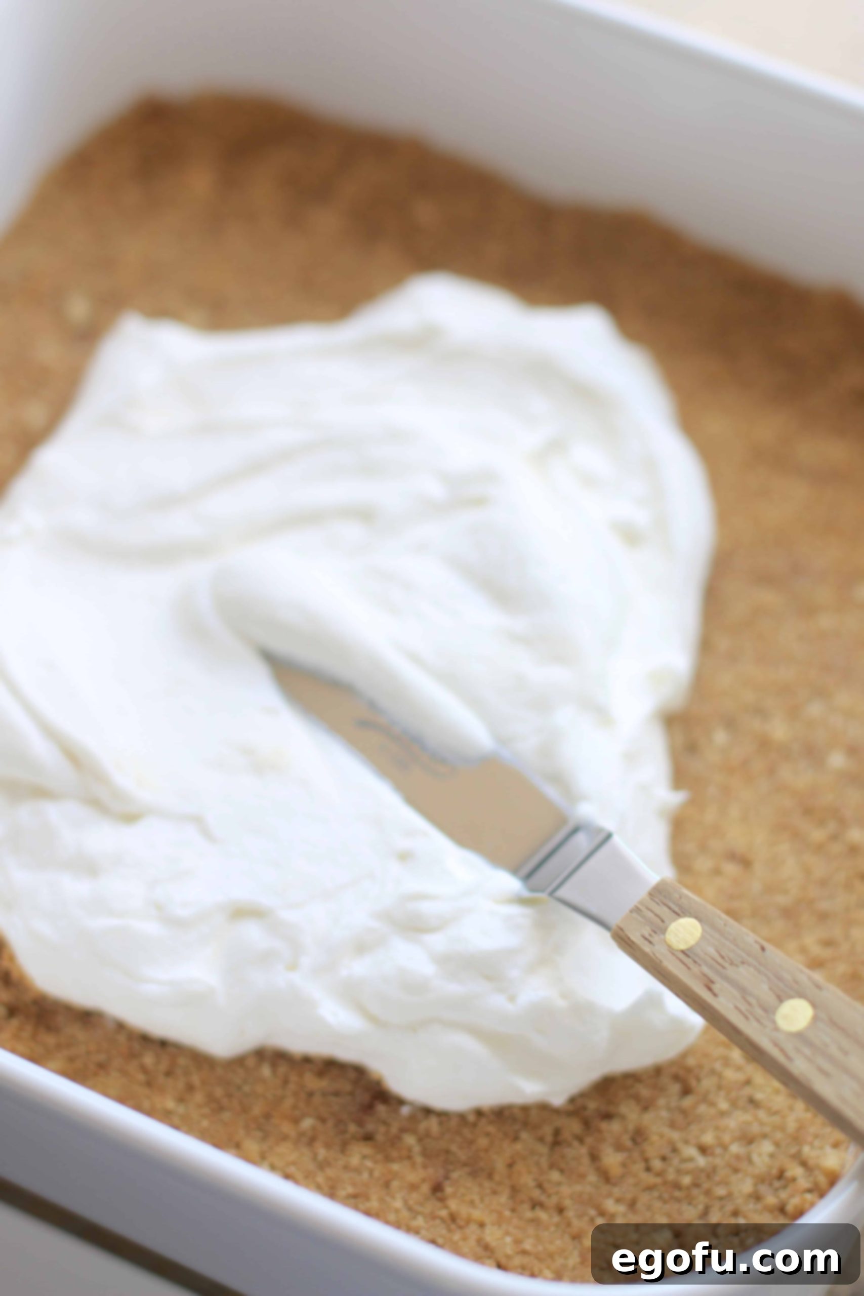 Sweetened cream cheese, whipped cream mixture spread on top of graham crackers.