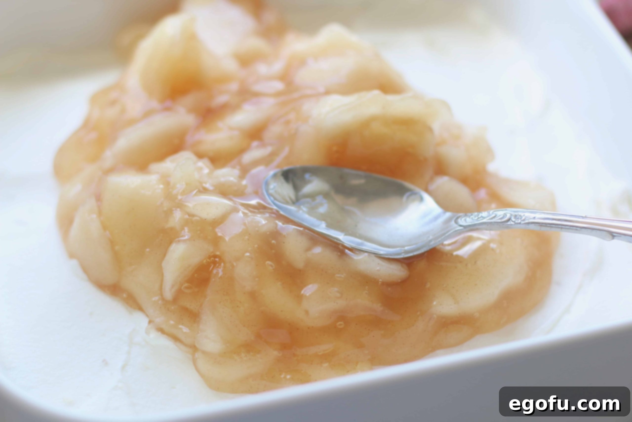 Chopped apple pie filling spread over whipped cream layer.