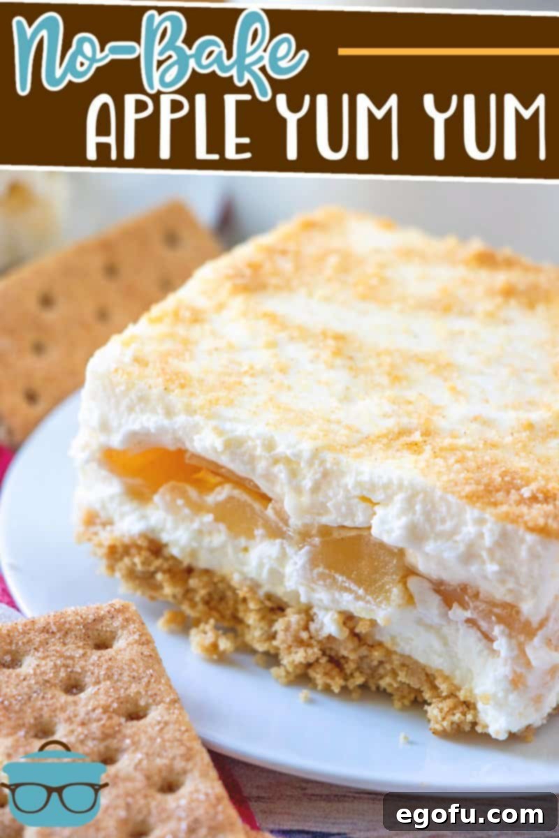No Bake Apple Yum Yum recipe from The Country Cook, slice shown on a small white plate with cinnamon graham crackers placed around the plate.