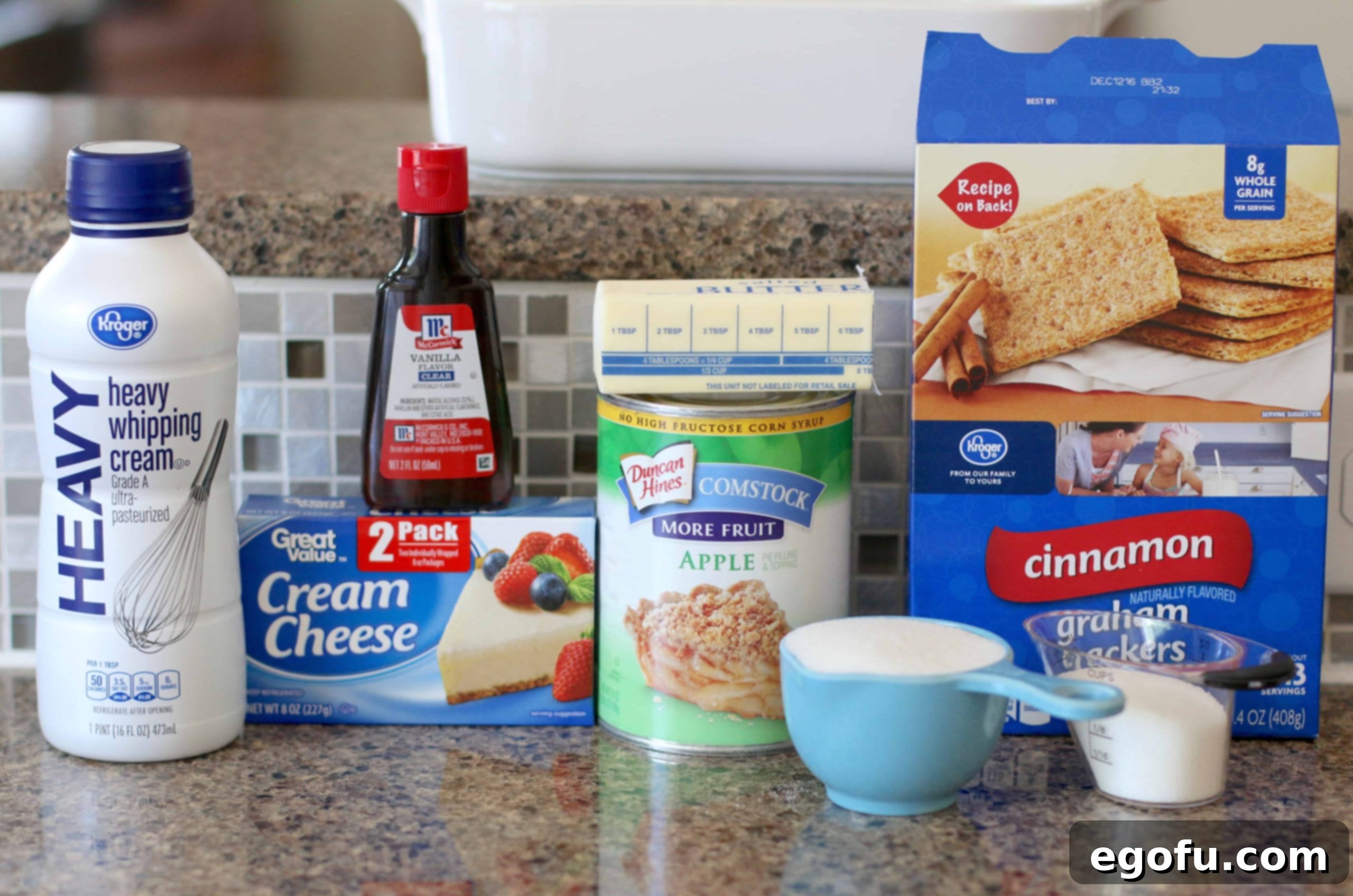 Ingredients needed for no-bake apple yum yum dessert: cinnamon graham crackers, salted butter, cream cheese, sugar, heavy whipping cream, vanilla extract, apple pie filling.