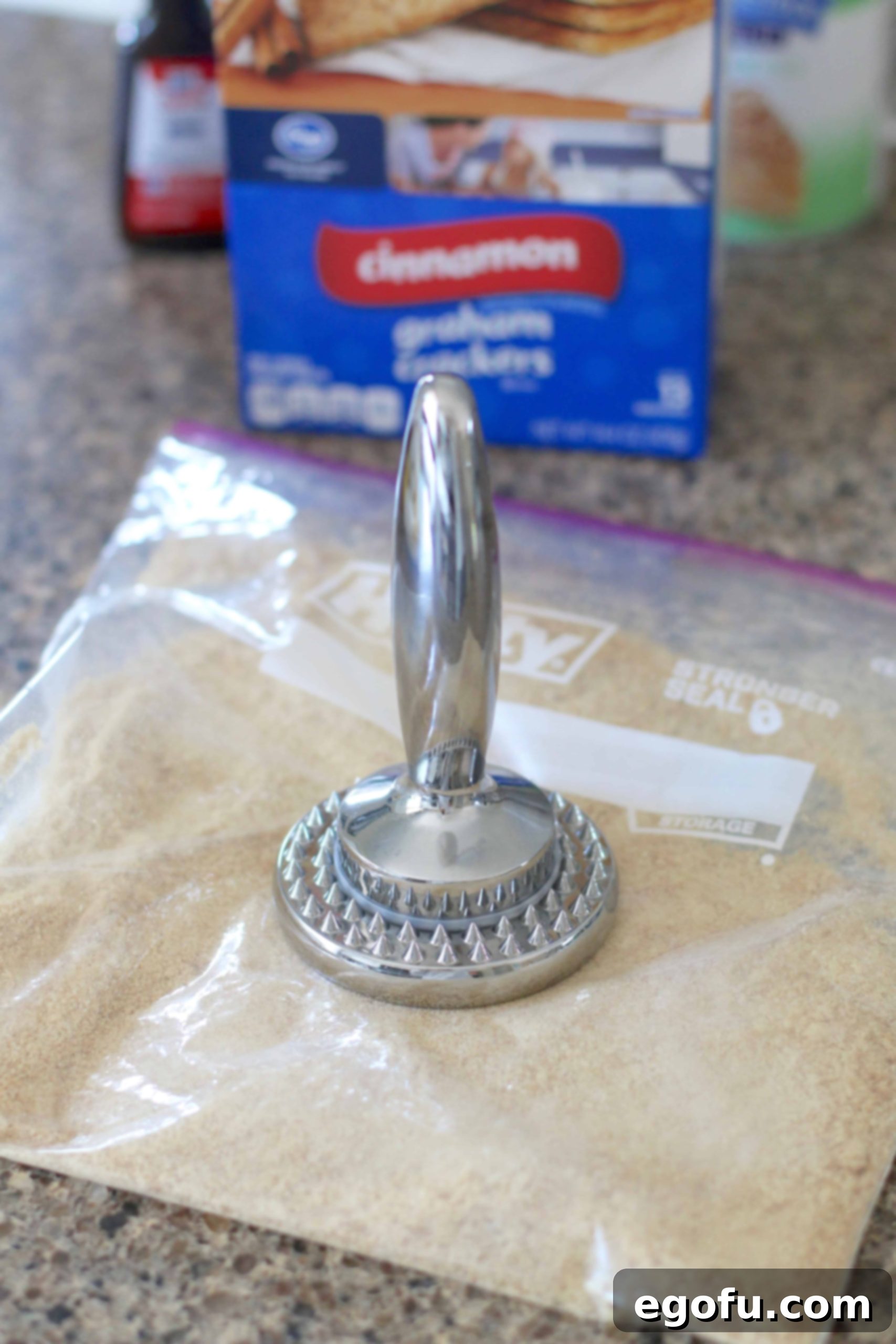Making graham cracker crumbs in a ziploc bag.