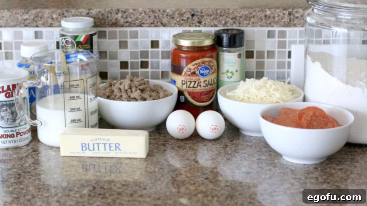 A collection of ingredients for homemade pizza pockets, including eggs, milk, garlic, flour, Parmesan, salt, baking powder, Italian seasoning, butter, pizza sauce, mozzarella, pepperoni, and sausage.