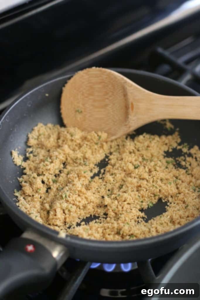Butter and dry bread crumbs sizzling in a small skillet over medium heat, creating a golden, crunchy topping.