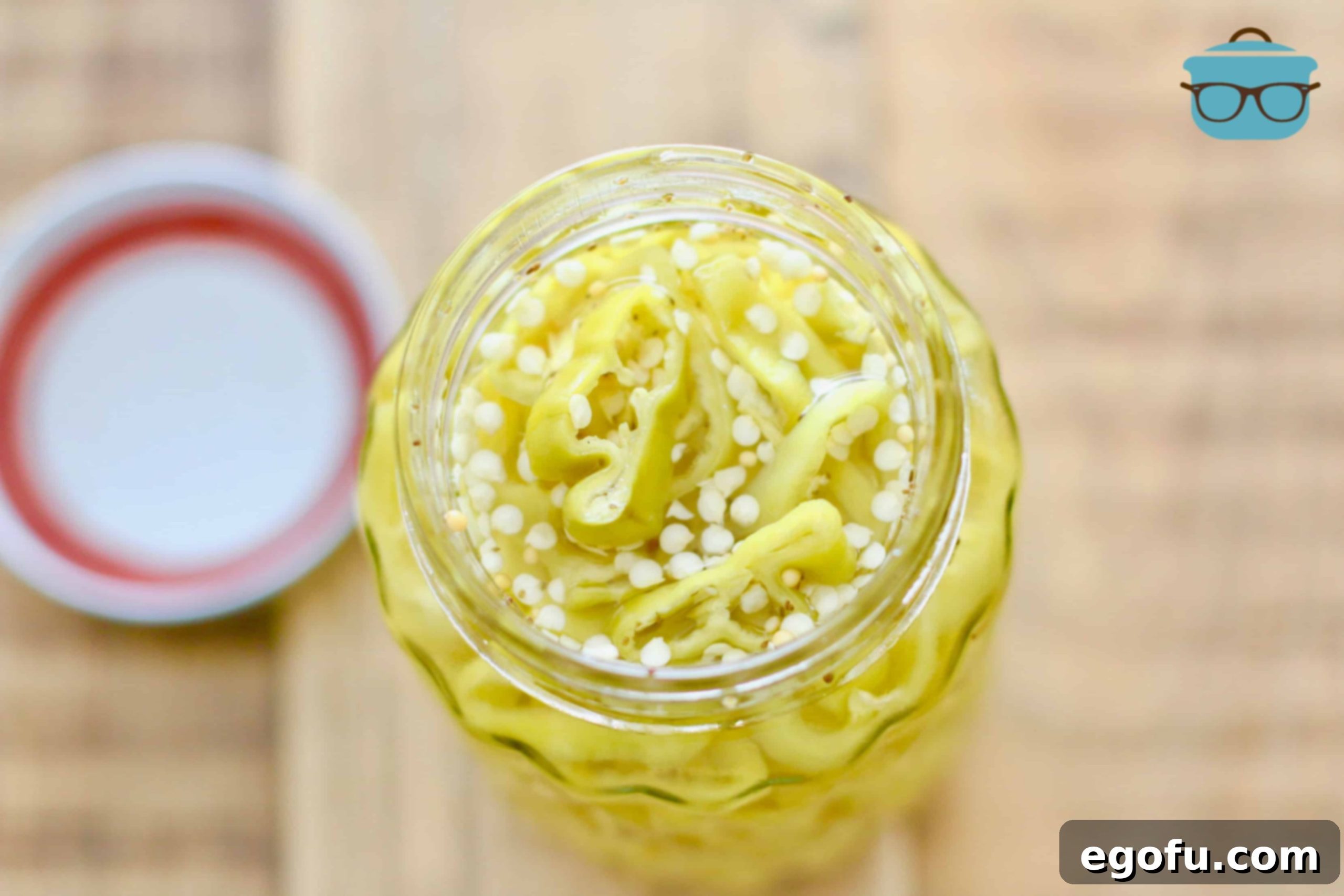 Garden Fresh Easy Pickled Banana Peppers in a ball mason pint jar, ready to be enjoyed.