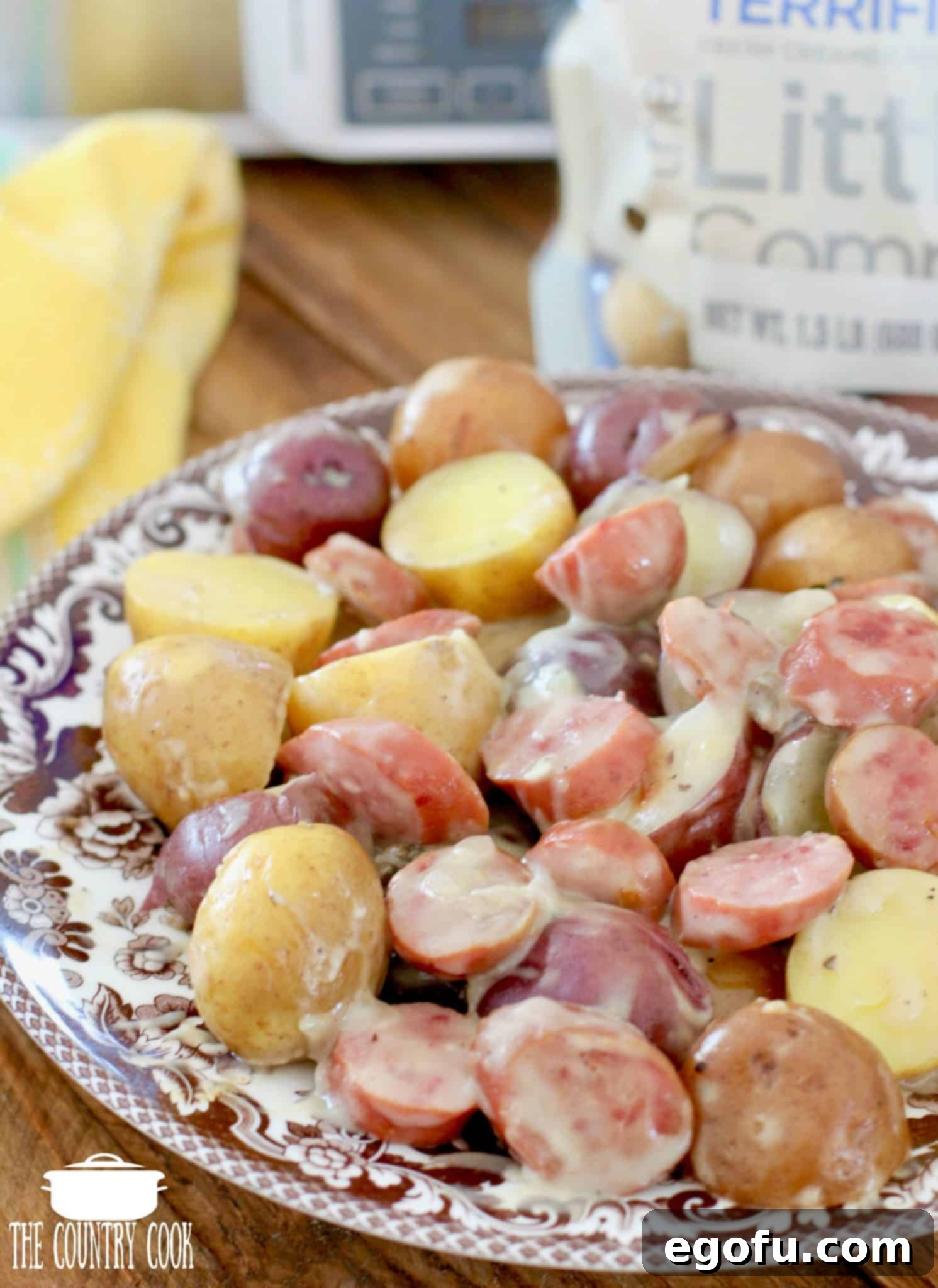 Easy Slow Cooker Creamy Sausage and Potatoes 9 A serving of Slow Cooker Creamy Sausage Potatoes in a bowl, garnished with fresh herbs, ready to be enjoyed.