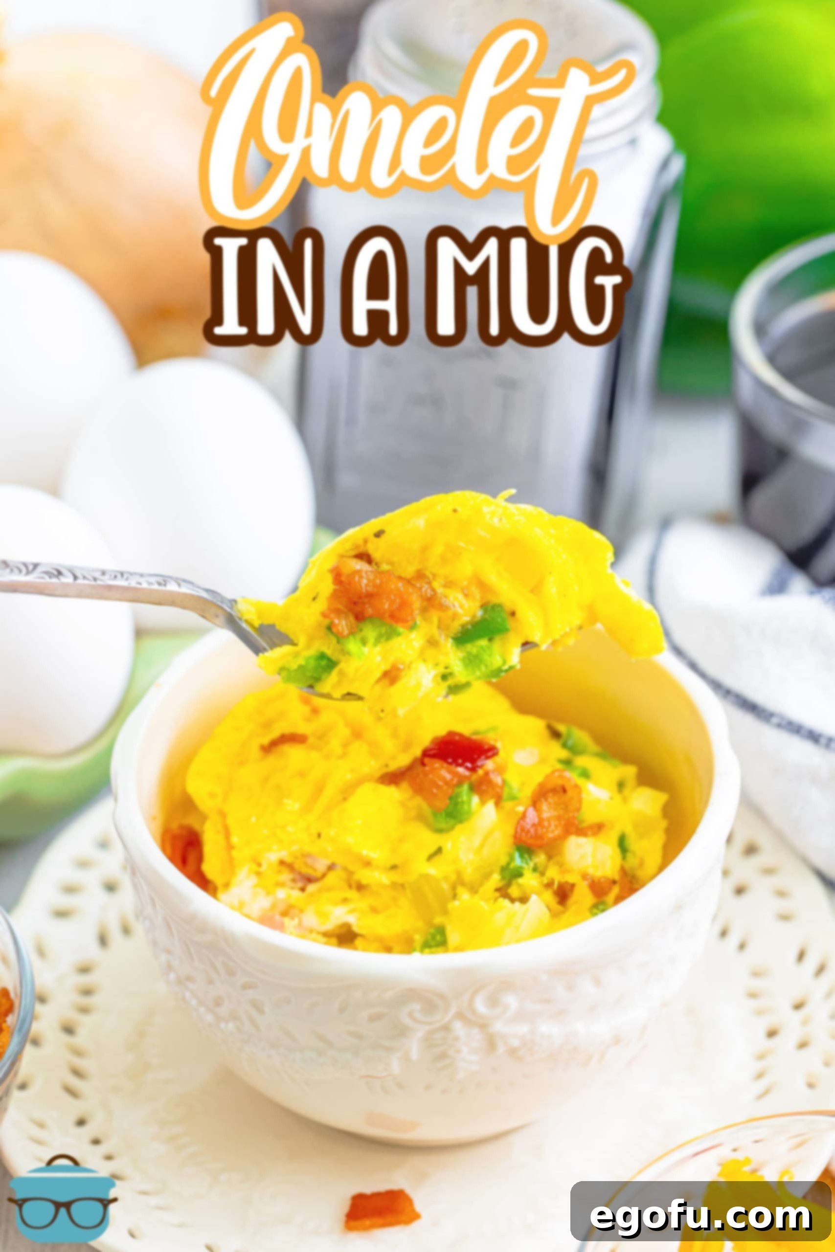 Your Instant Mug Omelet 3 A homemade Omelet in a Mug, with a fork gently removing a fluffy bite, highlighting its perfect texture.
