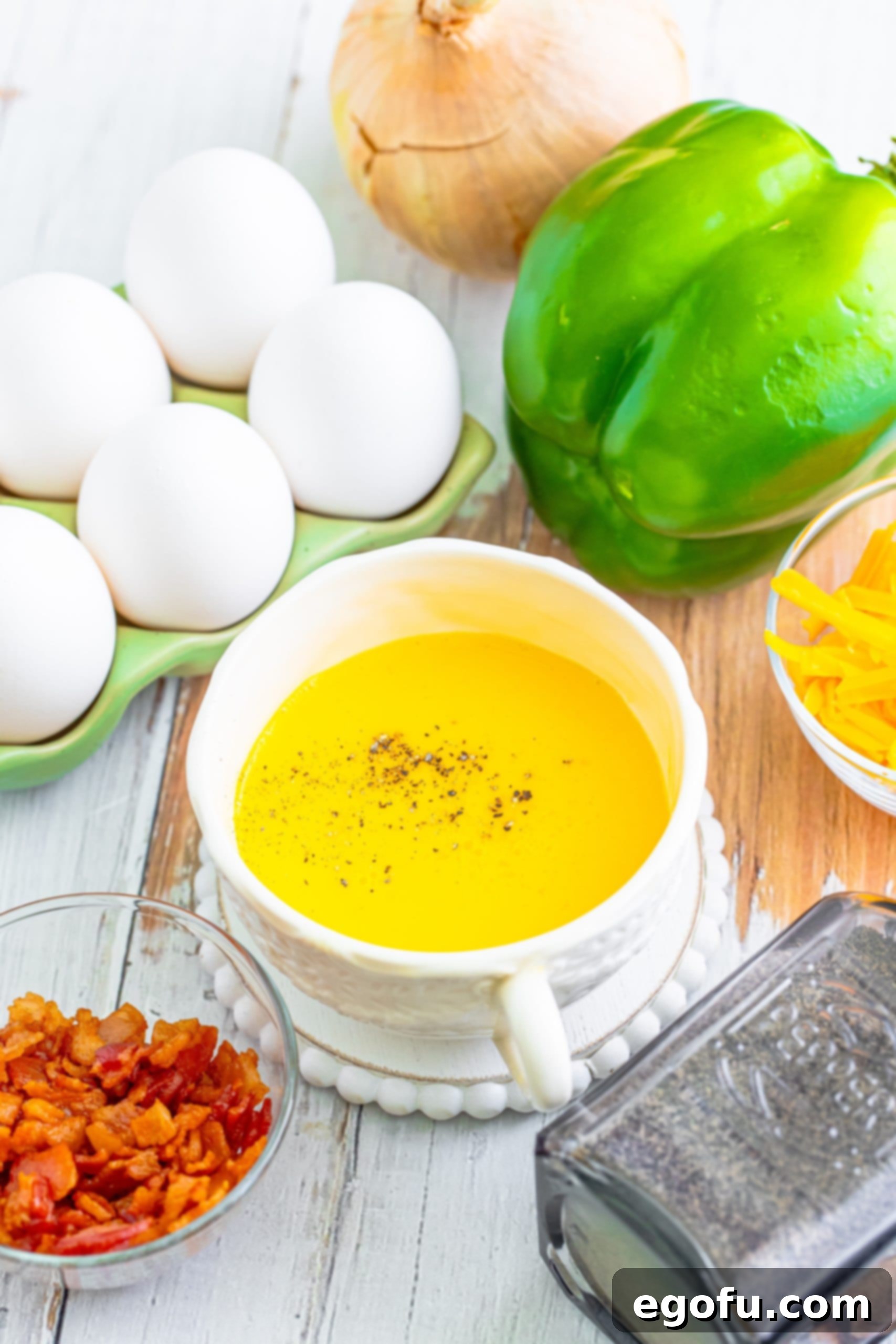 Your Instant Mug Omelet 6 A close-up of scrambled eggs in a mug, seasoned with salt and pepper, ready for the next delicious additions.