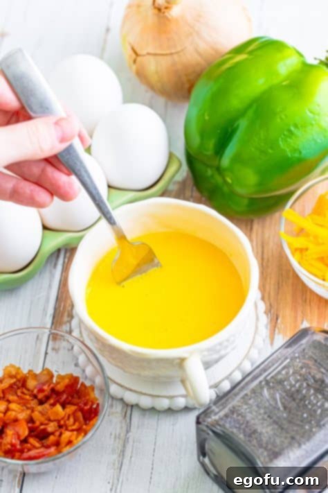 Your Instant Mug Omelet 10 A fork scrambling eggs in a mug.