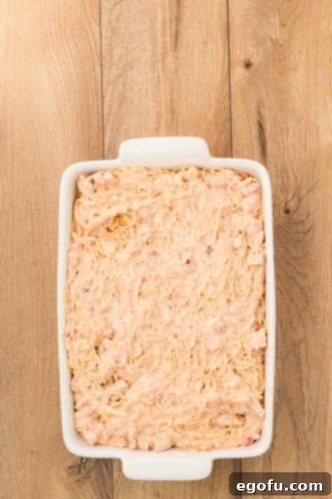 The chicken spaghetti mixture poured into a baking dish.