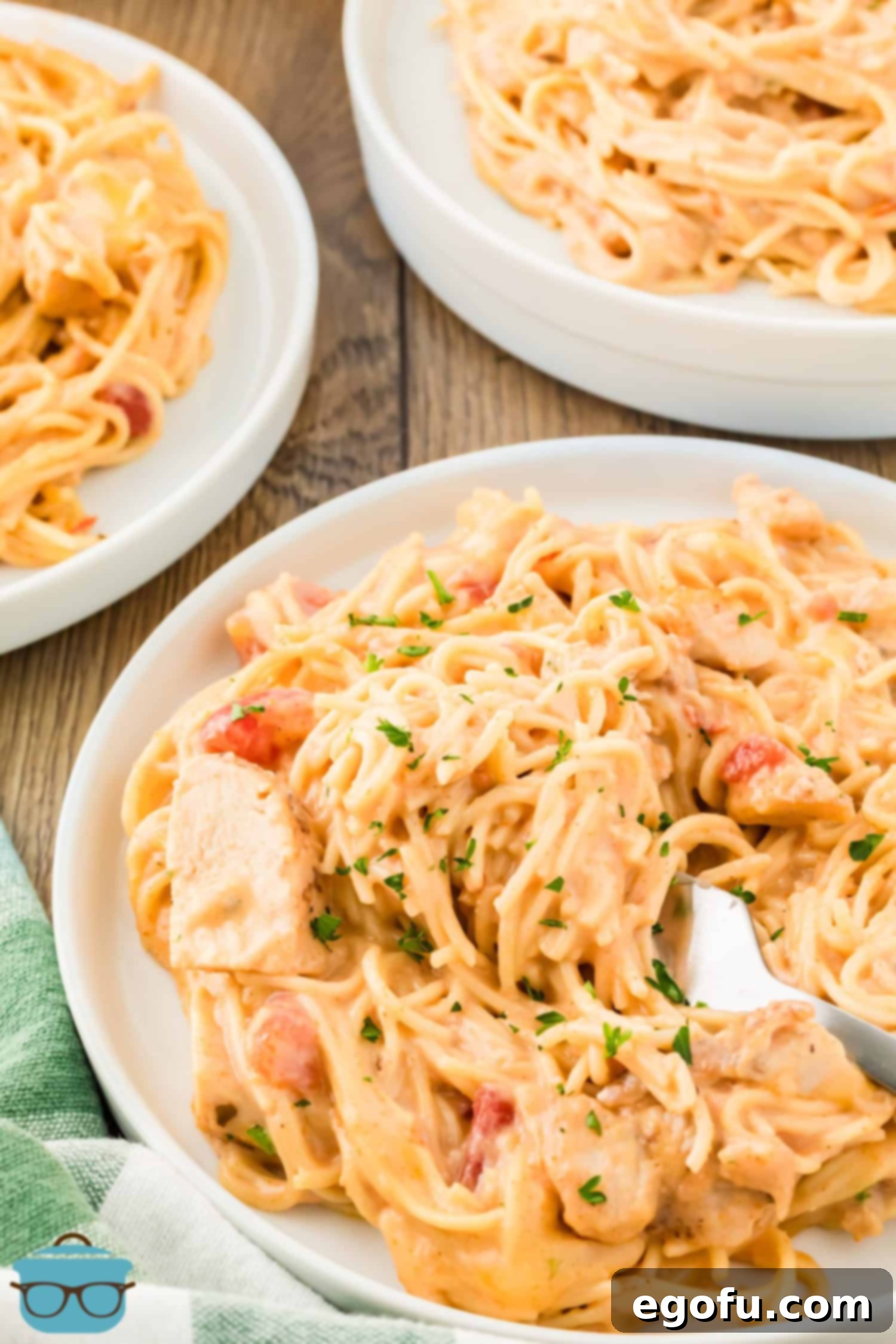 A few cozy bowls of freshly baked Chicken Spaghetti, garnished with a sprinkle of fresh herbs.